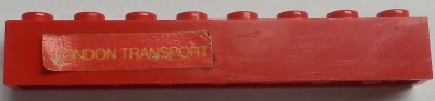 Lego Brick 1 x 8 with Yellow 'LONDON TRANSPORT' Text on Red Background Pattern Model Left Side (Sticker) - Sets 384 / 760-2