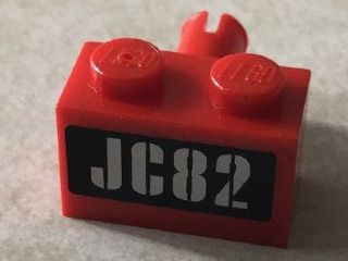 Lego Brick, Modified 1 x 2 with Pin with Silver 'JC82' on Black Background Pattern (Sticker) - Set 76006