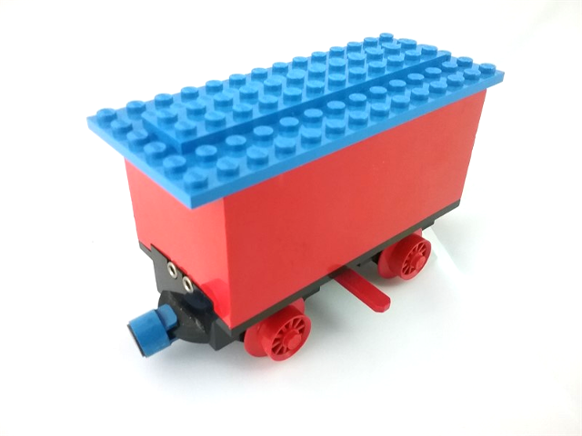 Lego Train Battery Box Car with Two Contact Holes, Red Switch Lever, Blue and Red Magnets, Red Wheels, and Blue Roof