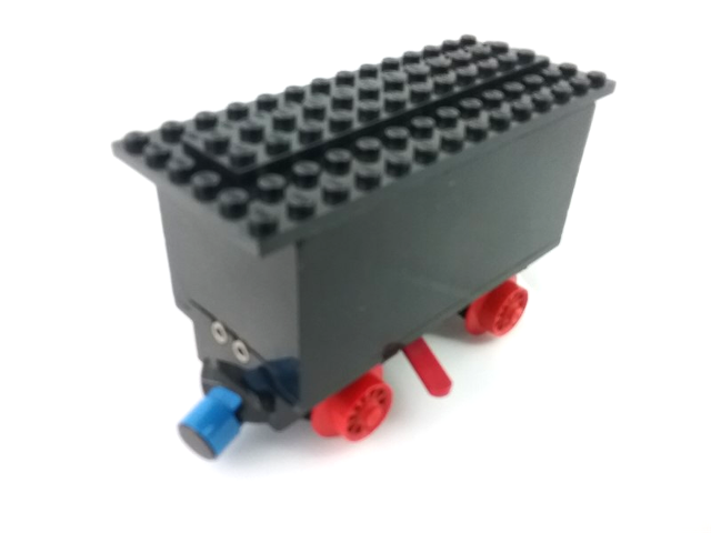 Lego Train Battery Box Car with Two Contact Holes, Red Switch Lever, Blue and Red Magnets, Red Wheels, and Black Roof