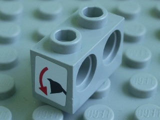 Lego Technic, Brick 1 x 2 with Holes with Black Digger Bucket and Red Curved Arrow Down on White Background Pattern (Sticker) - Set 8459