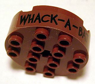 Lego Brick, Round 4 x 4 with 4 Side Pin Holes and Center Axle Hole with 'WHACK - A - BAT' Pattern (Sticker) - Set 7886