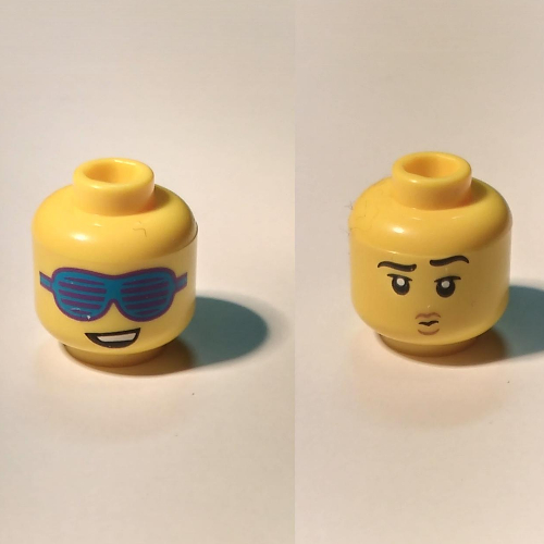 Lego Minifig Head, Dual Sided, Lopsided Smile and Large Slotted Blue Sunglasses / Raised Eyebrow, and Small Pouting Mouth / Yellow