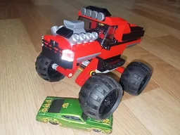 Red bigfoot pickup truck with suspension