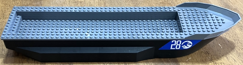 Lego Boat, Hull Unitary 51 x 12 x 6 with Side Bulges with Dark Bluish Gray Top with Silver '28' and Jurassic World Logo on Blue Background Pattern on Both Sides and Back (Stickers) - Set 76942