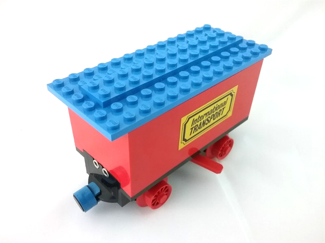 Lego Train Battery Box Car with Two Contact Holes, Red Switch Lever, Blue and Red Magnets, Red Wheels, and Blue Roof with 'International TRANSPORT' Pattern on Both Sides (Stickers) - Sets 161 / 181-1 / 183