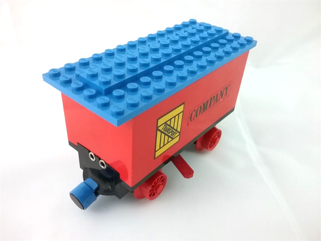 Lego Train Battery Box Car with Two Contact Holes, Red Switch Lever, Blue and Red Magnets, Red Wheels, and Blue Roof with 'TRANSPORT' on Yellow Box and 'COMPANY' Pattern on Both Sides (Stickers) - Set 180