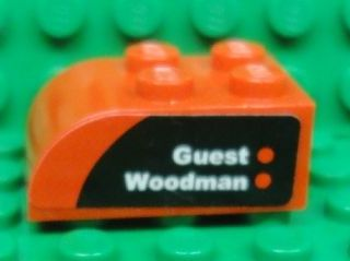 Lego Slope, Curved 3 x 2 with 4 Studs with 'Guest' and 'Woodman' on Black and Red Background Pattern Model Right Side (Sticker) - Set 8655
