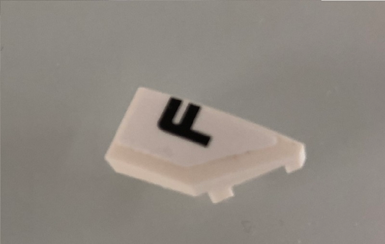 Lego Wedge 2 x 1 x 2/3 Right with Black Letter F on White Background Pattern (Sticker) - Set 42096
