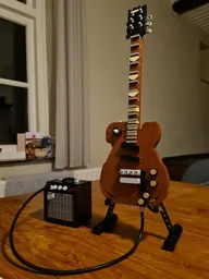 Gibson Les Pauls Guitar + Fender amp & display stand
