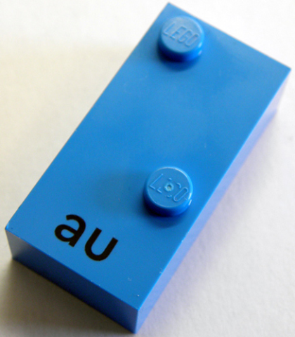 Lego Braille Brick 2 x 4 with 2 Studs ⠡ and 'au' print